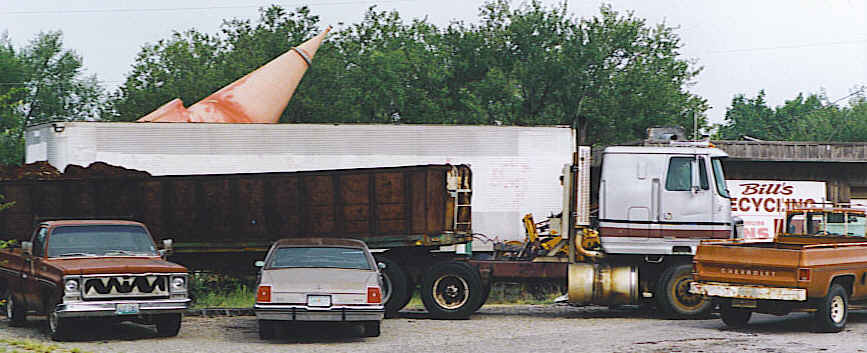 A large orange metal cone sits atop a flatbed trailer at Bill's Recycling yard